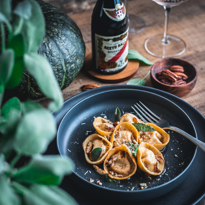 Balsamic-drizzled Pumpkin Tortelli with Brown Butter and Pecans